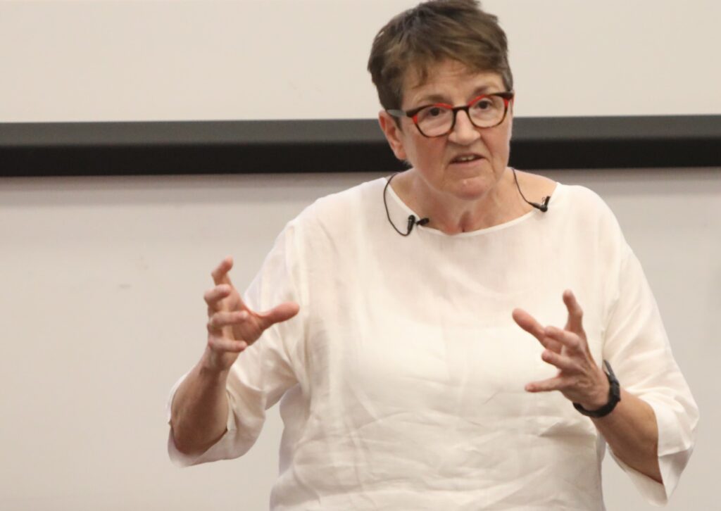 Lyn Roseaman giving a TEDxTalk inviting people to change their thoughts, feelings and actions about loneliness